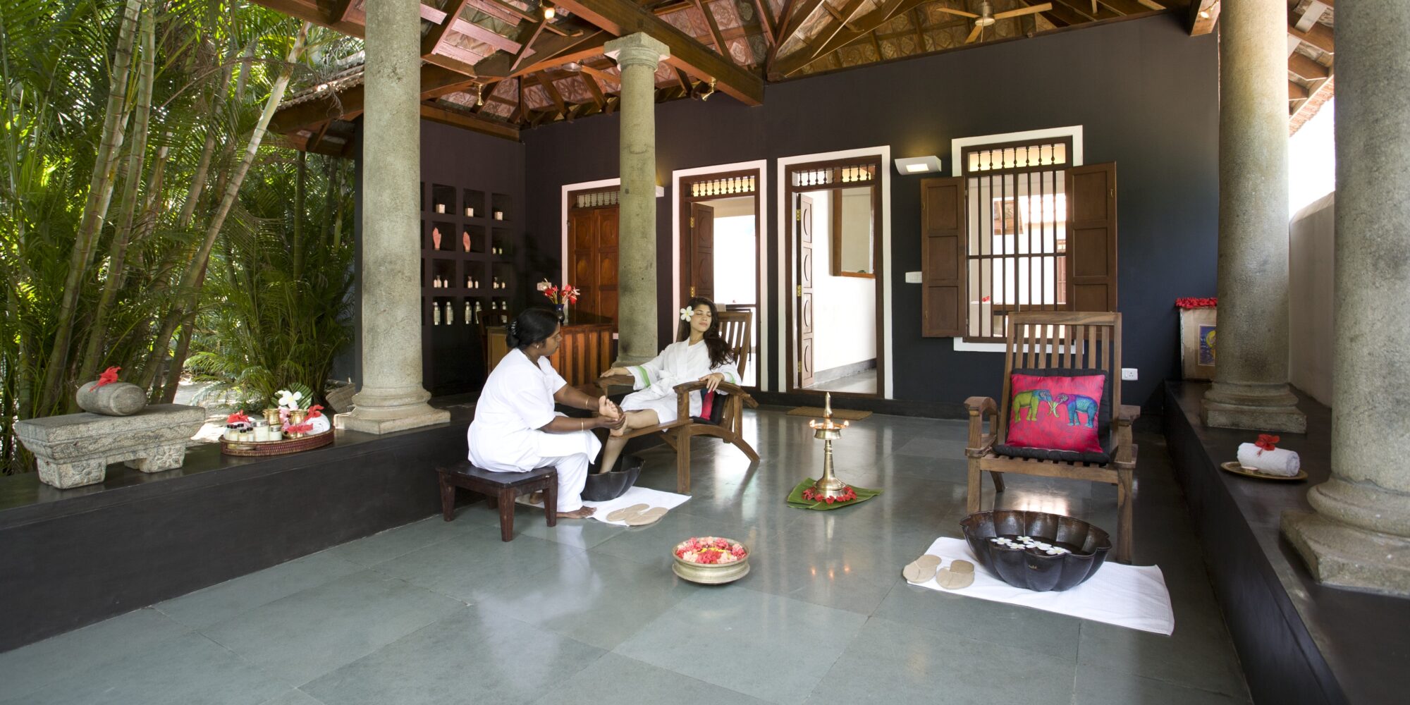 A guest getting a traditional Ayurvedic foot massage In Kerala, India. A guest getting a foot massage in India.