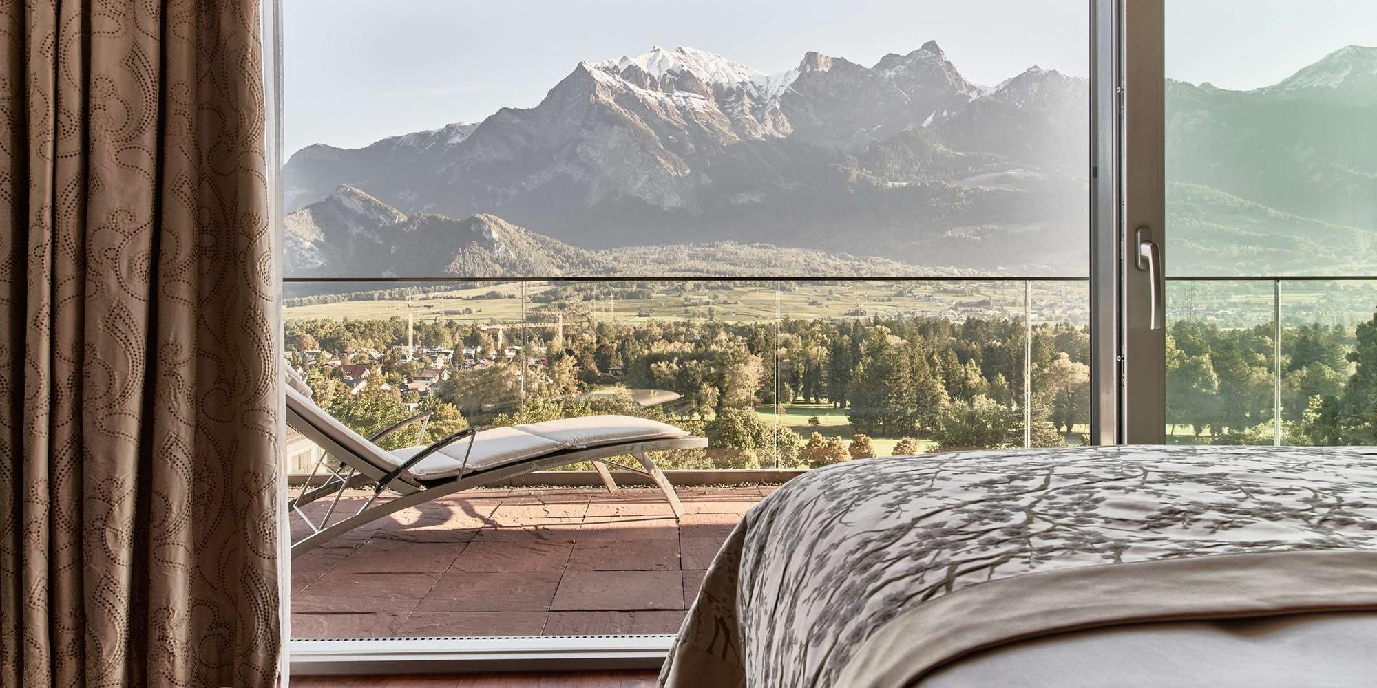 A picture showing an inside bedroom of the Grand Resort Bad Ragaz with a mountain view in Switzerland. An inside bedroom of the Grand Resort Bad Ragaz with a mountain view located in Switzerland.