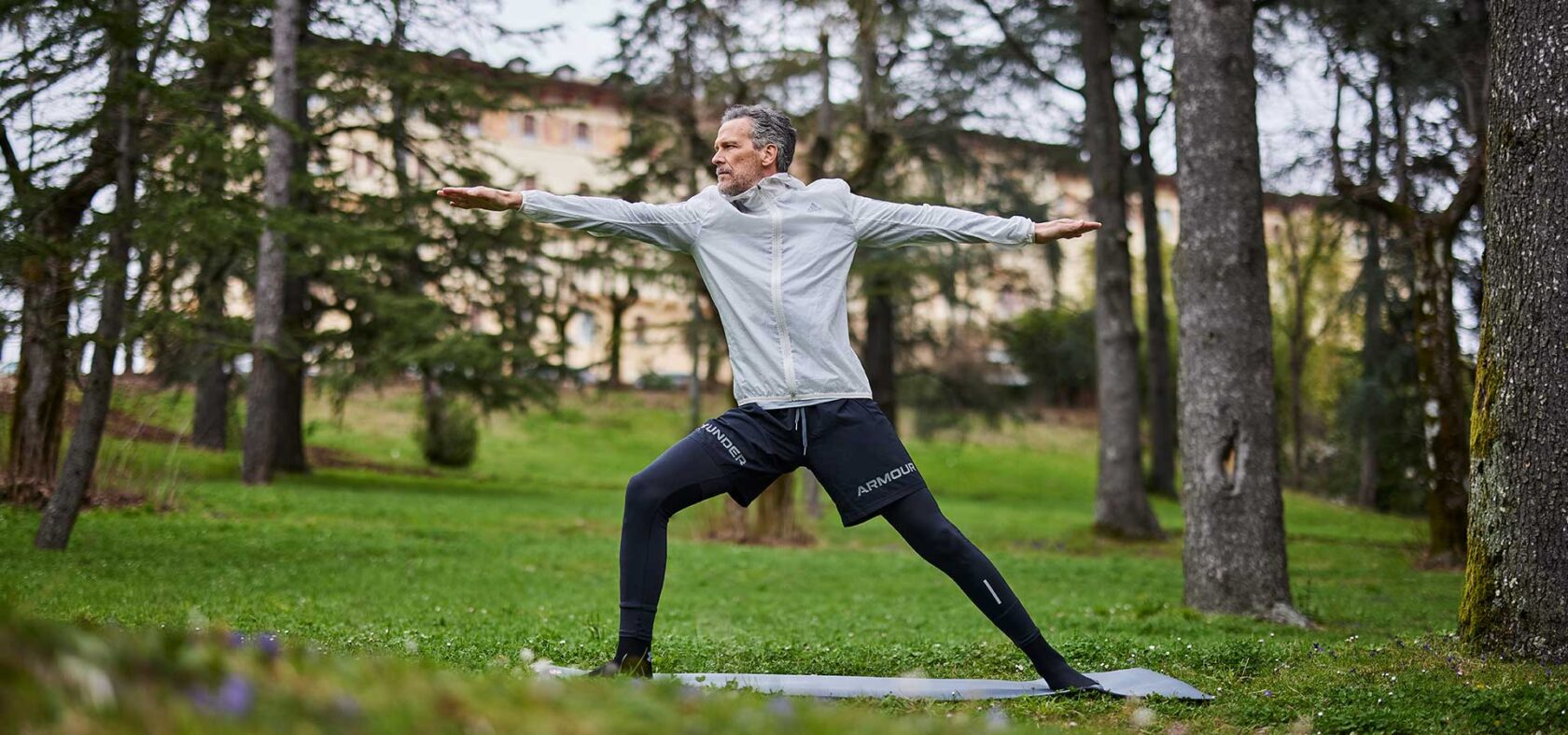 A guest practicing a yoga pose outdoors. A person practising a yoga pose.