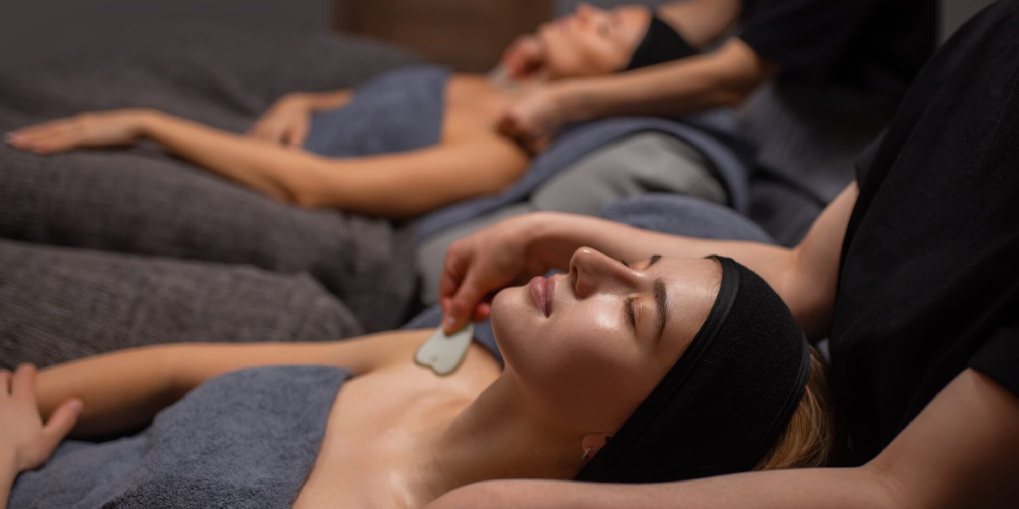 Image of guest wearing grey towels receiving a spa treatment. Guest receiving a spa treatment.
