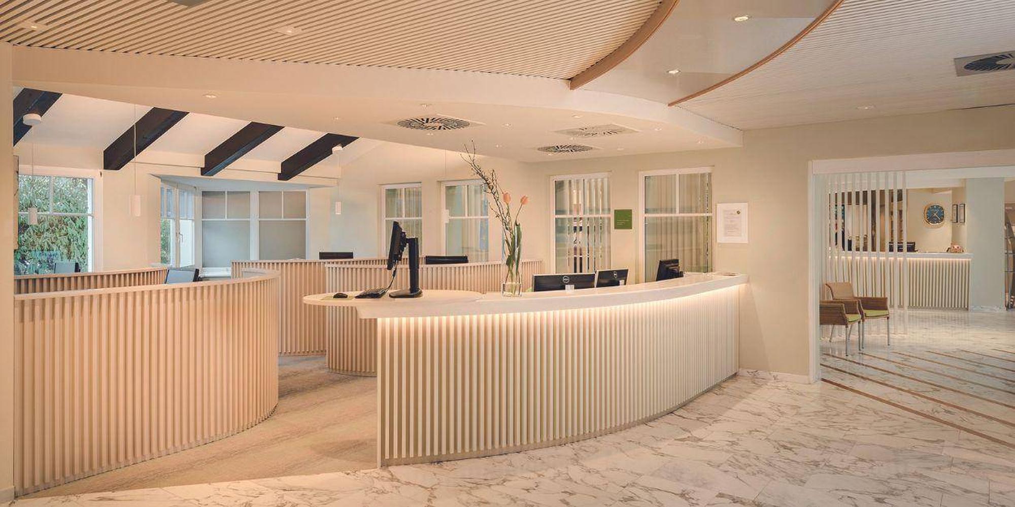 A picture of reception area in Park Igls resort, Austria with a white fluted panel design. A reception area in Park Igls, Austria.