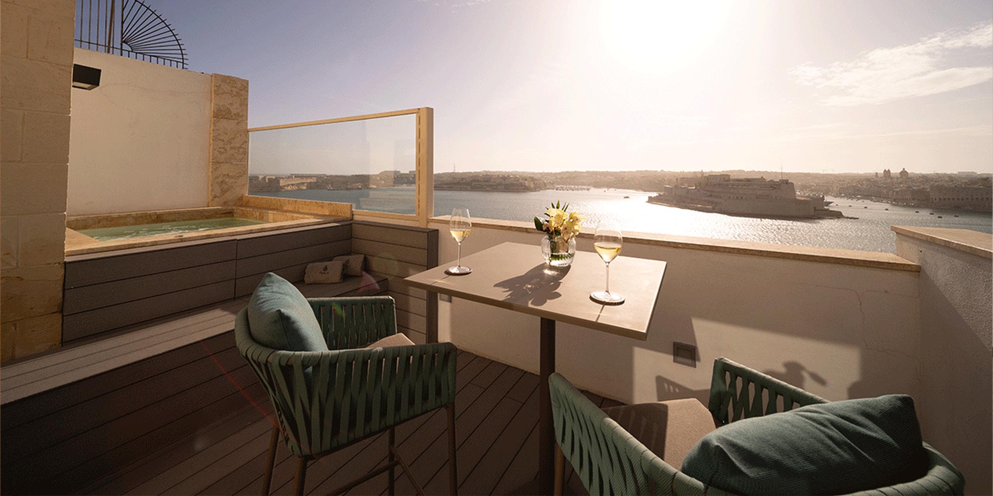 An image of a terrace overlooking a coastal landscape at Iniala Harbour House in Malta. A terrace area overlooking a coastal landscape at Iniala Harbour House in Malta