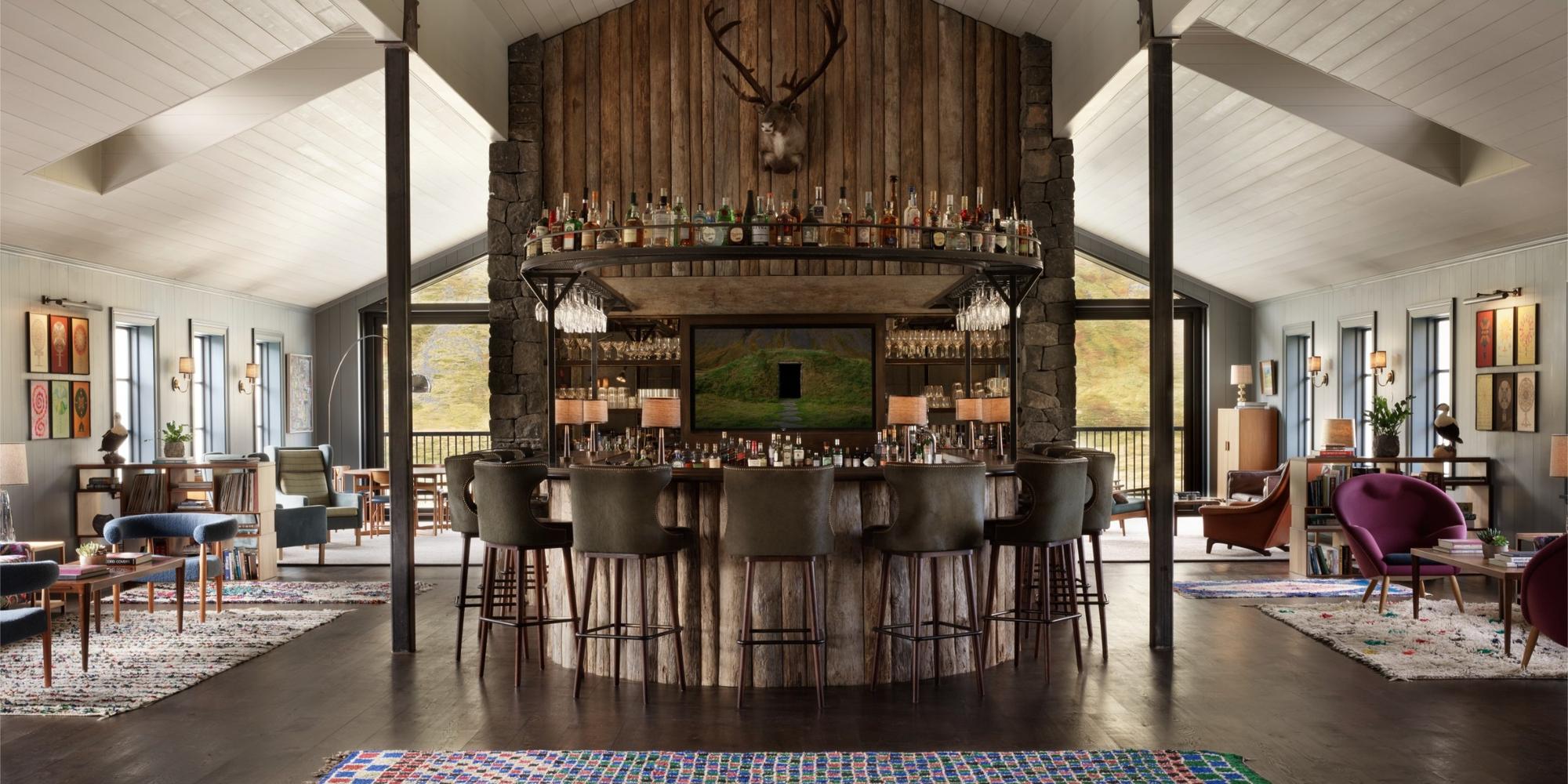 The bar features a distinctive log-cabin style design at Deplar Iceland. A rustic luxury bar located at Deplar Farm, Iceland.