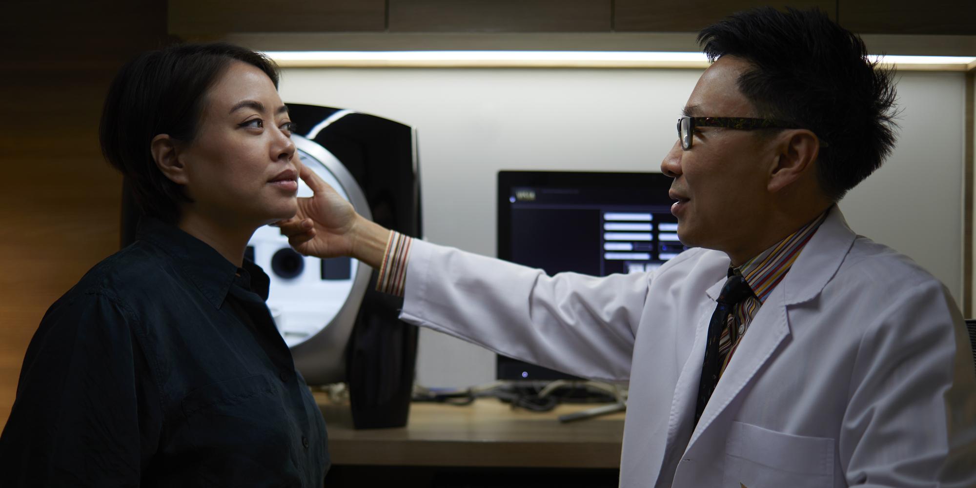 An image of doctor conducting a professional facial skin assessment on a guest at RAKxa Bangkok. A doctor conducting a professional facial skin assessment at RAKxa Bangkok.