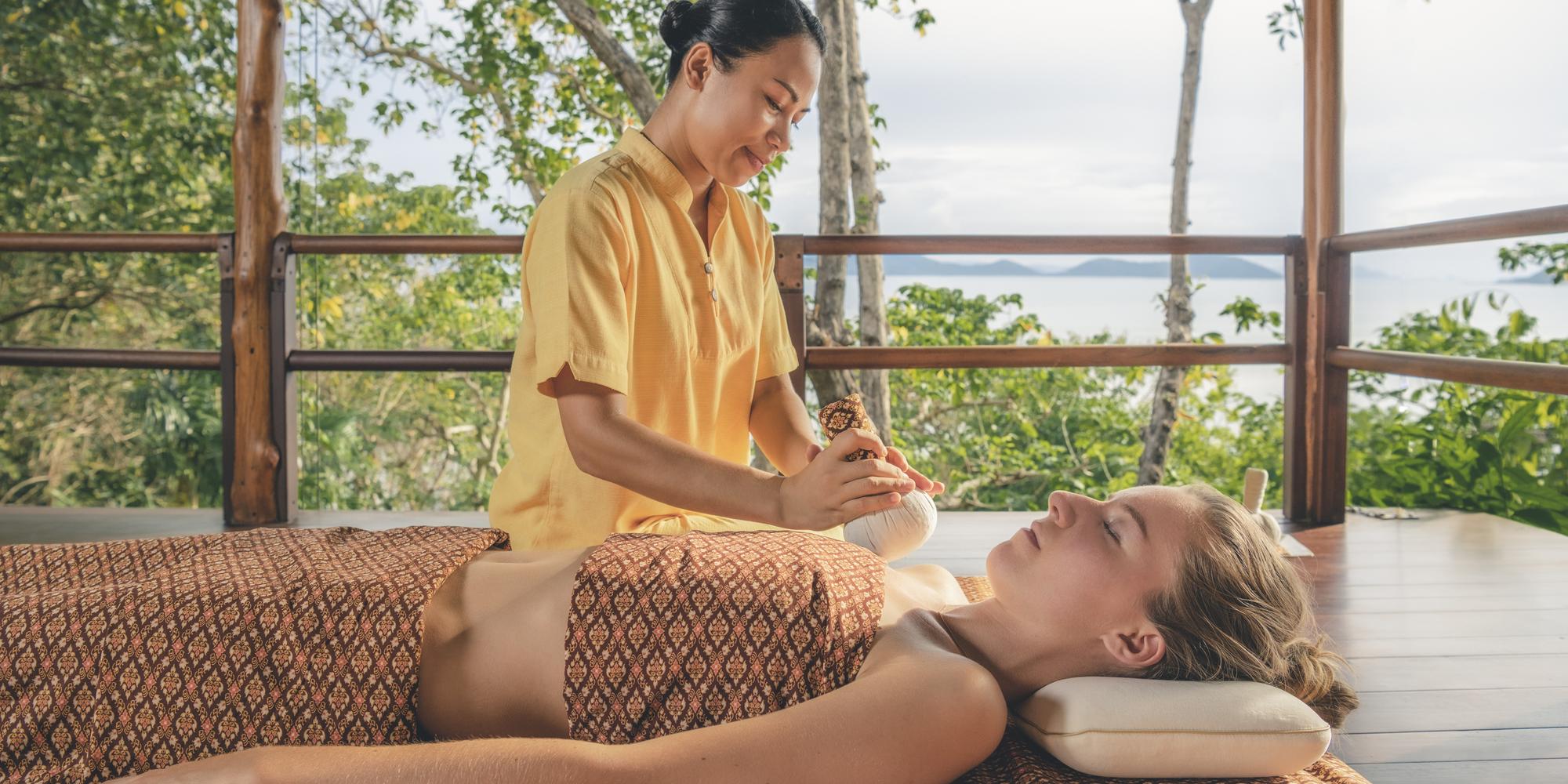 An employee performing a Thai massage on a guest at Kamalaya in Asia. An employee performing a Thai massage on a guest at Kamalaya in Asia.