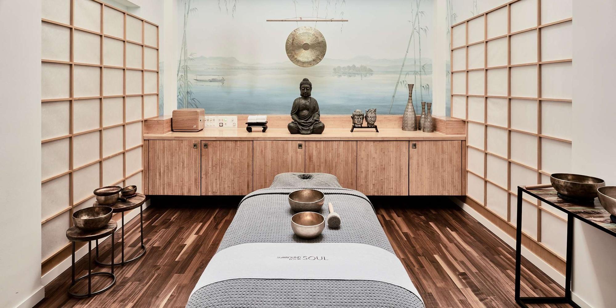 The Japandi-style spa room features a modern wooden storage unit and a minimalist Buddha stature at Grand Resort Bad Ragaz, Switzerland. The Japandi-style spa room features a modern wooden storage unit and a minimalist Buddha stature at Grand Resort Bad Ragaz, Switzerland.
