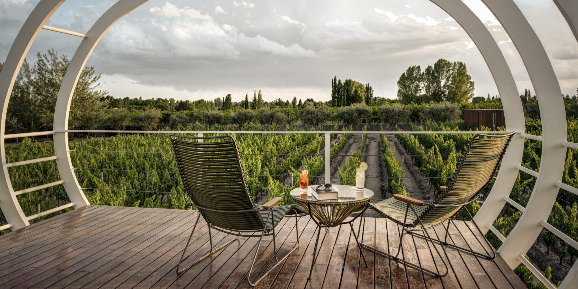 An image featuring a doomed terrace structure overlooking vineyard rows at Entre Cielos Wine & Wellness Hotel in Argentina. An image featuring a doomed terrace structure overlooking vineyard rows at Entre Cielos Wine & Wellness Hotel in Argentina.